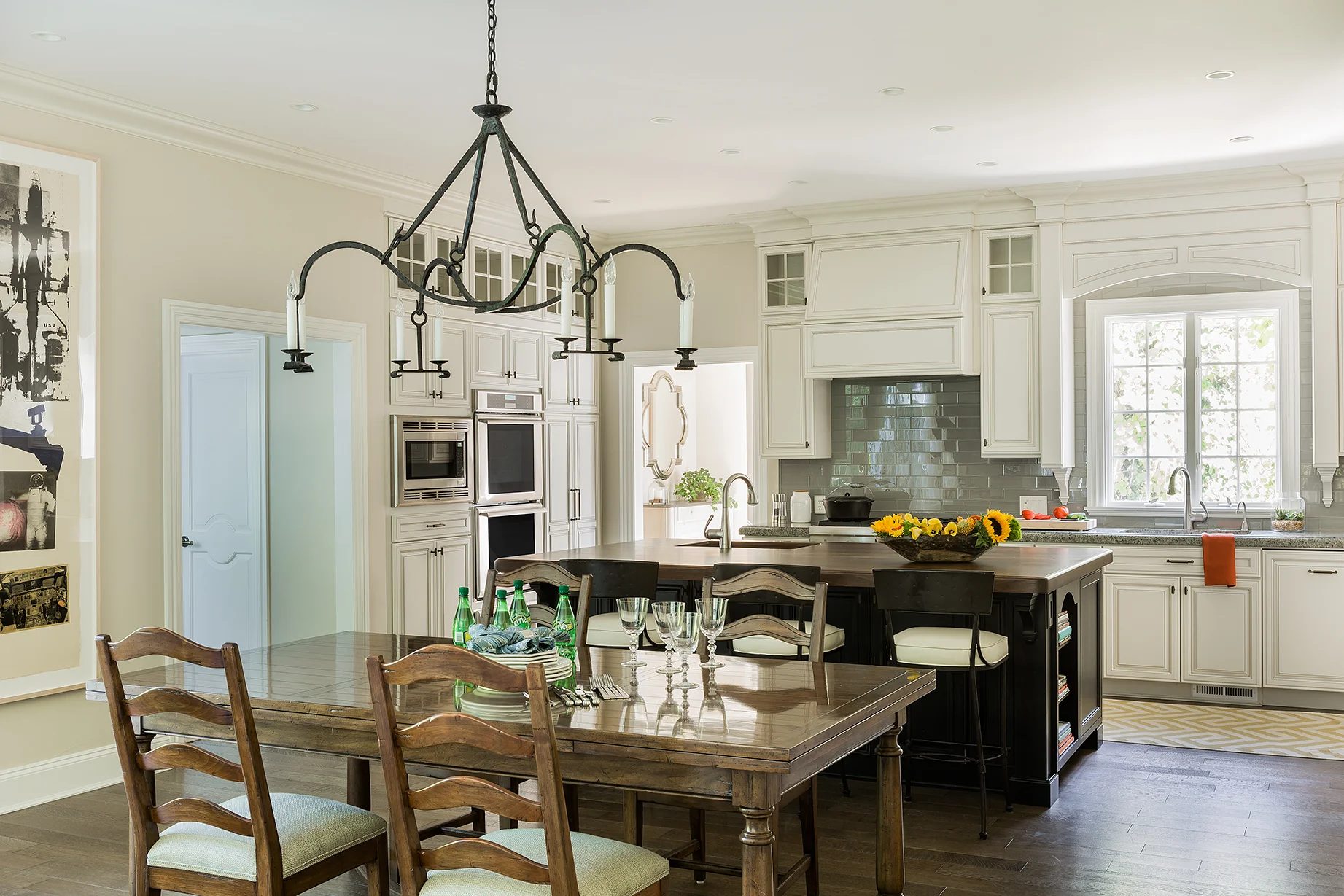 A completed KitchenVisions kitchen with white cabinetry and a wide center island